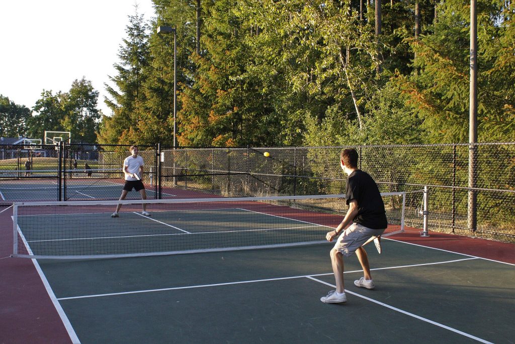 Two pickleball players competing at the net during a doubles match